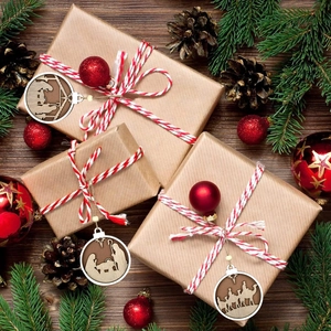 Detailed wood carved Christmas ornaments featuring nativity scenes on gift boxes