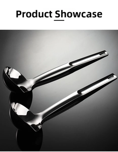 Close-up of two polished stainless steel oil separator spoons with convenient hanging holes