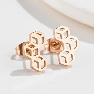 Macro detail of geometric rose gold honeycomb earrings with a modern hollow square design