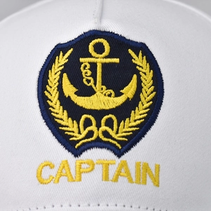 White nautical captain baseball cap featuring gold anchor embroidery and navy text