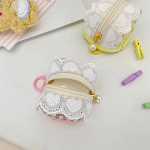 Detail of cute fabric earphone cases with heart lace and pearl zipper pull features