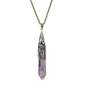 Detailed view of purple hexagonal crystal pendant with bronze hollow metal cap and chain