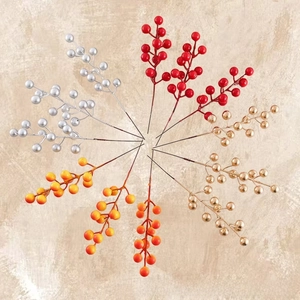 Macro detail of artificial Christmas berries in red silver and gold for home holiday decor