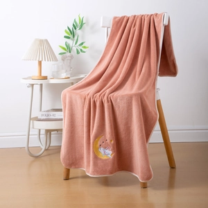 Pink coral fleece bath towel featuring soft texture and cute moon rabbit embroidery
