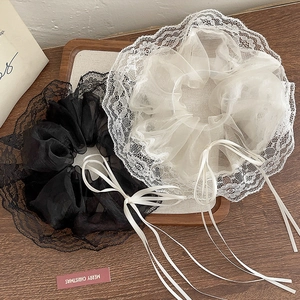 Detail of black and white lace organza hair scrunchies with long silk ribbons