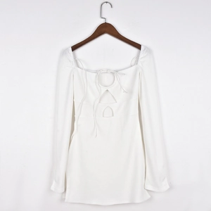 Close-up of white waffle knit dress with square neck and lace-up cutout detail