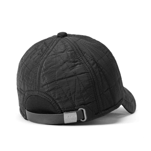 Close-up of quilted black baseball cap featuring premium leather strap and metal buckle detail