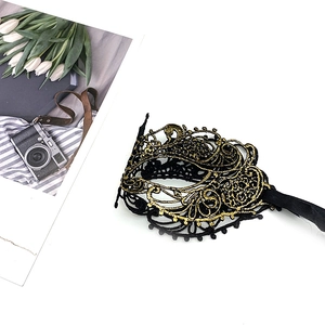 Detail of black lace masquerade mask with elegant gold embroidery for Halloween parties