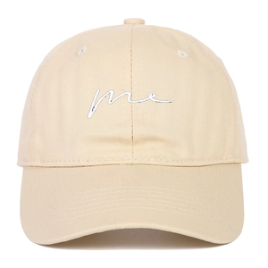 Close-up of light beige baseball cap with me script embroidery and twill cotton texture