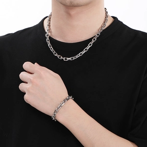 Detail of silver OT buckle stainless steel chain necklace and bracelet on male model