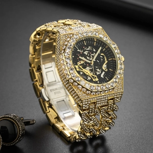 Detail of gold iced-out watch with hollow skeleton dial and diamond-encrusted band