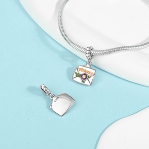 Close-up of S925 sterling silver envelope charm with flower and THANKS engraving