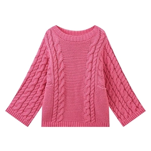 Detail of chunky cable-knit texture and flared cuffs on pink crewneck sweater