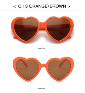Detail of orange heart-shaped sunglasses with brown lenses and positive front view