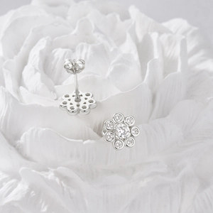Macro detail of 925 silver flower stud earrings with sparkling cubic zirconia crystals