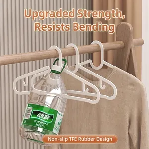 White non-slip plastic hanger with TPE rubber grip showing heavy-duty weight capacity