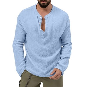Detail of light blue wrinkled fabric texture on a long sleeve henley shirt for men