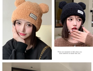 Detail of cute bear ear plush knit hat with lambswool texture and brand patch