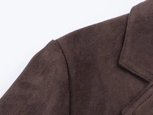 Close-up of chocolate brown faux suede jacket showing shoulder stitching and soft texture
