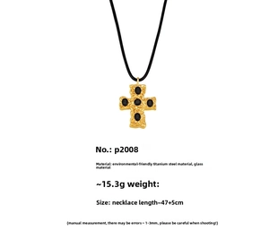 Detailed view of 18K gold plated cross pendant with five oval black glass gemstones