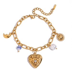 Detail of vintage gold layered bracelet with sun, moon, and heart pendants on white background
