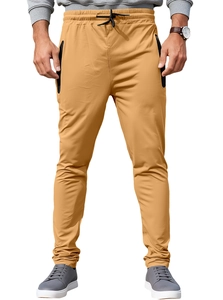 Detailed close-up of khaki athletic joggers with zipper pockets and ergonomic tailoring