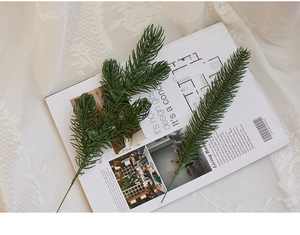 Detailed view of artificial green PE pine needles used for Christmas tree decoration