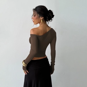 Detail of the off-shoulder neckline and rich dark brown fabric of this slim-fit top
