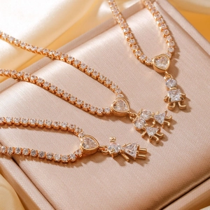 Three gold hip-hop heart necklaces with zircon pendants on champagne silk and box