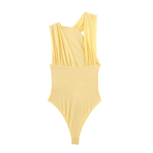 Detail of light yellow one-shoulder bodysuit with elegant pleated tulle texture
