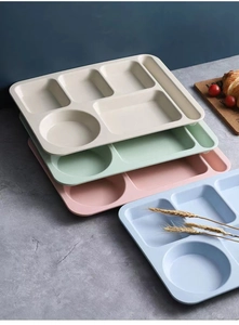 Detail of eco-friendly wheat straw divided meal plates in four soft pastel colors