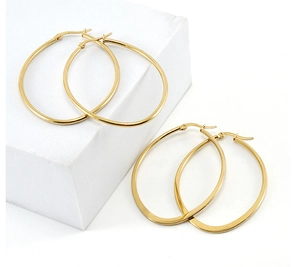 Detail of 18K gold plated titanium steel hoop earrings on a white geometric prop