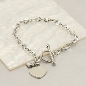 Silver stainless steel double heart charm bracelet with OT toggle clasp on marble