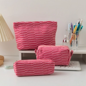 Detailed close-up of pink checkered knitted storage bags showing soft woven texture