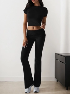Close-up of black short sleeve crop top and high-waist flare pants casual set for women