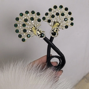 Gros plan détaillé d'un chignon paon doré avec des cristaux de zircon verts et blancs