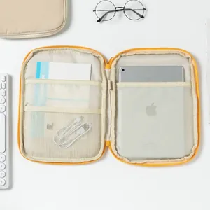 Detail view of yellow laptop sleeve interior with multiple pockets and tablet slot