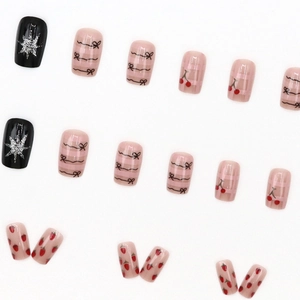 Press-on nail set with cartoon bows, cherry patterns and silver star designs on white backdrop