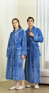Detail of royal blue flannel robe with white contrast piping and soft plush texture