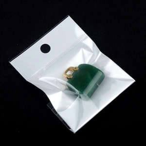 Green crystal handbag pendant with gold handle on black background in mini size