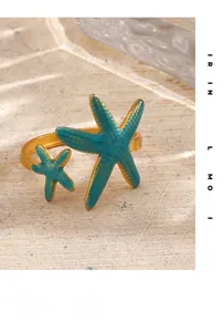 Macro detail of 18K gold-plated starfish ring with turquoise enamel and textured finish