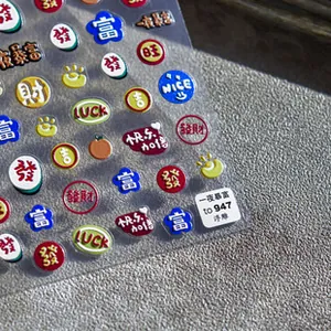 Macro shot of 5D embossed nail art stickers with lucky symbols and textured surface