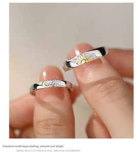 Macro shot of sun and moon couple rings featuring brushed metal texture and gold plating