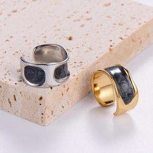 Close-up of irregular textured open rings with starry pattern in gold and silver