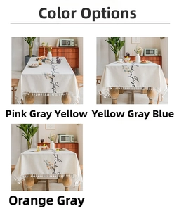 Close-up of linen tablecloth featuring tassel fringe and abstract floral print designs
