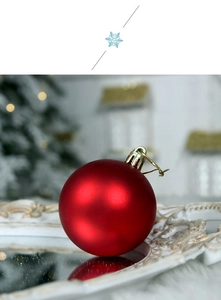 Detail of red glossy Christmas ball on a vintage gold tray with festive background