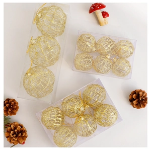 Macro view of gold hollow glitter Christmas ball ornaments in multiple gift box sets