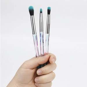 Detailed view of 3-piece crystal handle makeup brushes with blue gradient bristles