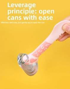 Pink paw-shaped opener using lever principle to lift the pull ring of a pet food can