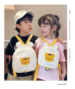 Children wearing cute canvas bear backpack with tiger embroidery and yellow straps